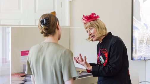 A house volunteer explains something to a visitor at The Vyne.